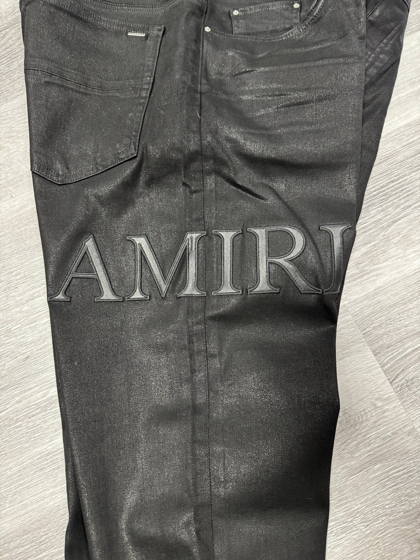 Amiri Black Serif Logo Wax Denim Jeans